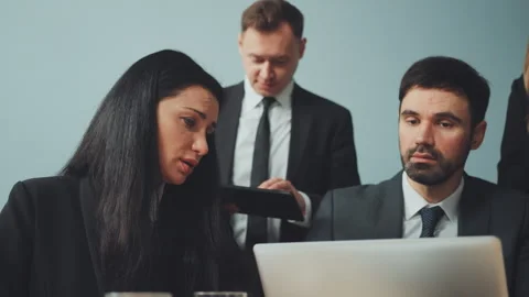Business Team Analyzing Data on Laptop and Discussing Project Details Stock Footage 278678591