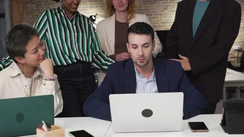 Business team analyzing data on laptop in office Stock Footage 313339337