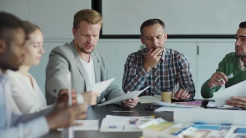 Business team analyzing data in meeting Stock Footage 142557804