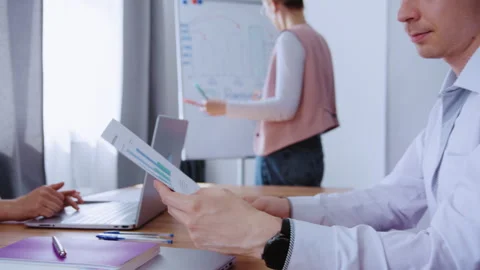 Business team analyzing financial data during corporate meeting Stock Footage 339608798