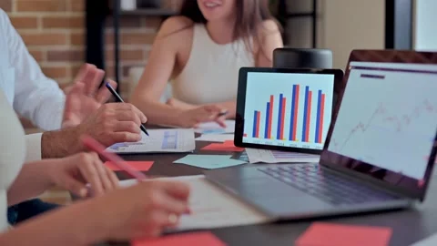 Business team analyzing financial data on tablet and laptop during office m.. Stock Footage 339663119