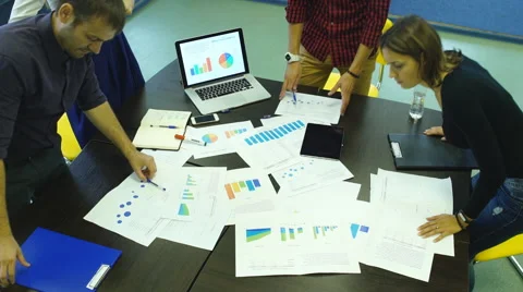 Business team analyzing financial documents Stock Footage 67989797