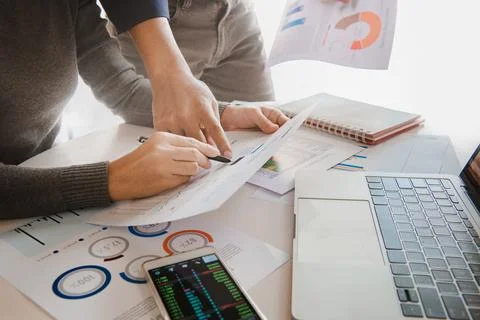 Business team analyzing sales data and economic growth graph chart on offic.. Stock Photos