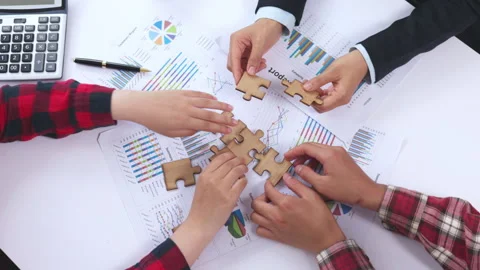 Business team assembling a jigsaw puzzle during a corporate meeting. Teamwo.. Stock Footage 338004535