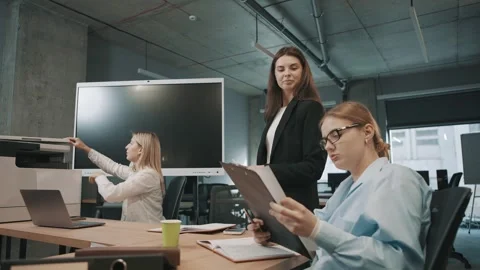 Business team collaborates in an office environment discussing documents Video stock 312256584