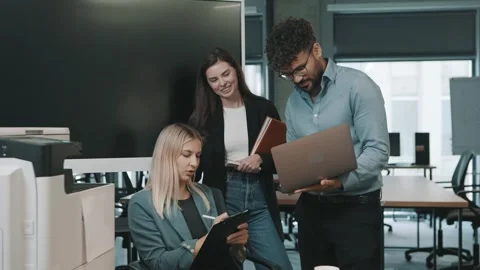 Business team collaborates on project with documents and laptops Stock Footage 318523776