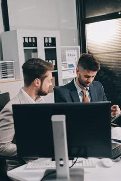 Business team collaborating on digital data analysis in modern office Stock Photos