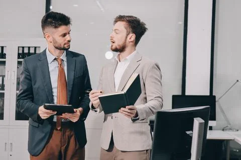 Business team collaborating on digital data analysis in modern office Stock Photos