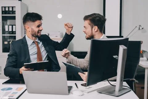 Business team collaborating on digital data analysis in modern office Stock Photos