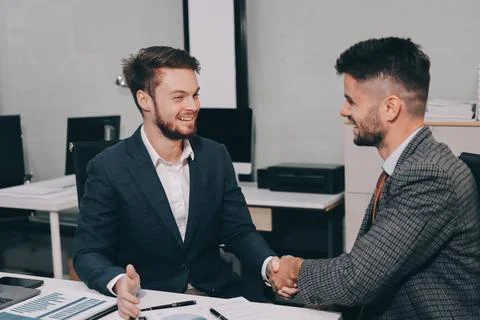 Business team collaborating on digital data analysis in modern office Stock Photos