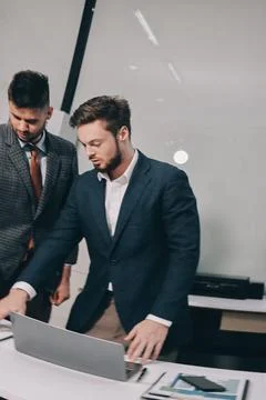 Business team collaborating on digital data analysis in modern office Stock Photos