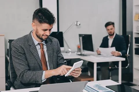 Business team collaborating on digital data analysis in modern office Stock Photos