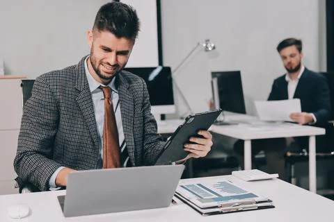 Business team collaborating on digital data analysis in modern office Stock Photos
