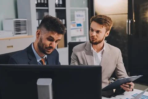 Business team collaborating on digital data analysis in modern office Photos