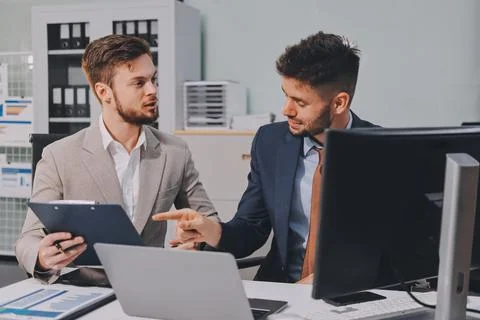 Business team collaborating on digital data analysis in modern office Photos