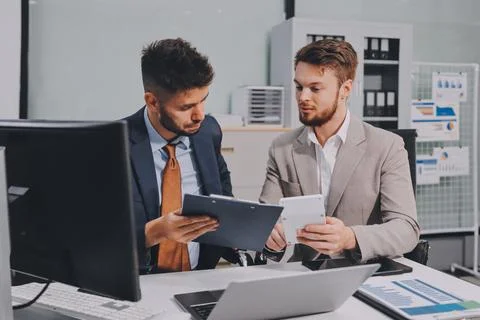 Business team collaborating on digital data analysis in modern office Photos