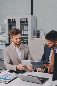 Business team collaborating on digital data analysis in modern office Photos
