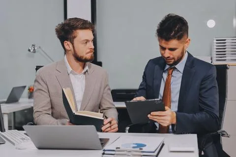 Business team collaborating on digital data analysis in modern office Photos