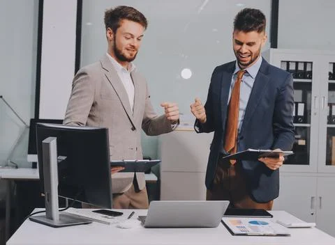Business team collaborating on digital data analysis in modern office Photos