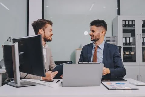 Business team collaborating on digital data analysis in modern office Photos