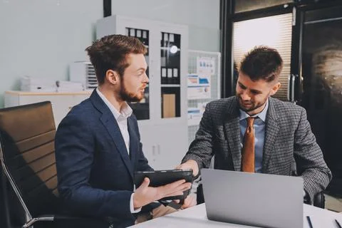 Business team collaborating on digital data analysis in modern office Photos