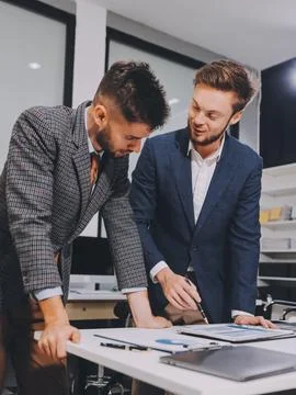 Business team collaborating on digital data analysis in modern office Photos