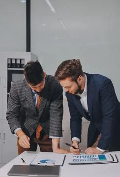Business team collaborating on digital data analysis in modern office Photos