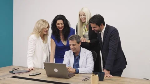 Business team collaborating on a project using a laptop Stock Footage 335274816