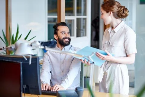 Business team with computer and files in office Stock Photos