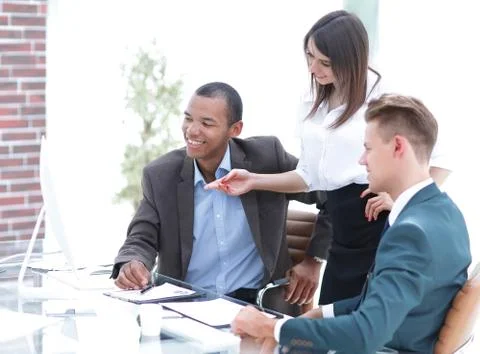 Business team discussing work problems sitting at their Desk Stock Photos
