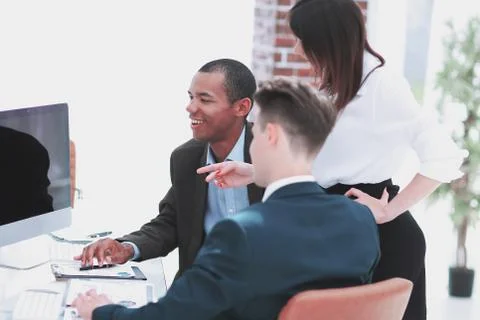 Business team discussing work problems sitting at their Desk Stock Photos