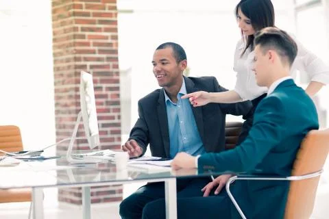 Business team discussing work problems sitting at their Desk 스톡 사진