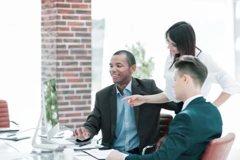 Business team discussing work problems sitting at their Desk Stock Photos
