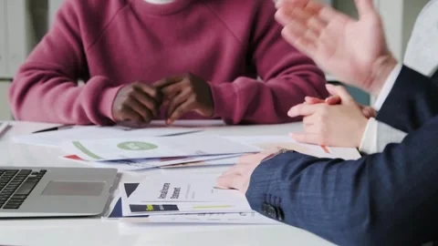 Business team with documents and laptop at wooden table computer. Close up Stock Footage 334654070