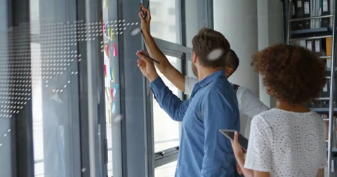 Business team examining phone notes annotating glass wall and capturing layout Stock Footage 312230175