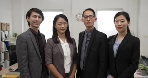 Business team of four smiling at camera Video stock 225601559