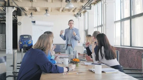 Business team fun discussing a presentation. A male manager answers questions Stock Footage 111647859