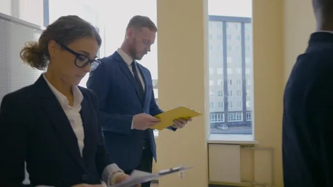 Business team going on elevator and talking Stock Footage 121149395