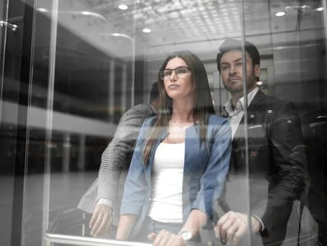 Business team group going on elevator. Stock Photos