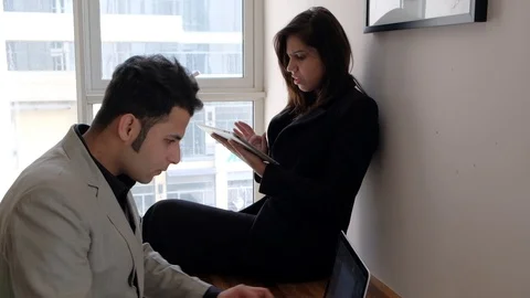 Business team hard at work for solutions working on the same table on a laptop a Video stock 100629250