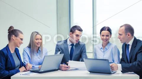 Business team with laptop having discussion Stock Photos