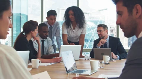 Business Team With Laptops Around Table In Modern Office Collaborating Stock Footage 302684404