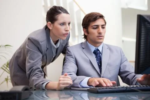 Business team looking at computer screen together Stock Photos
