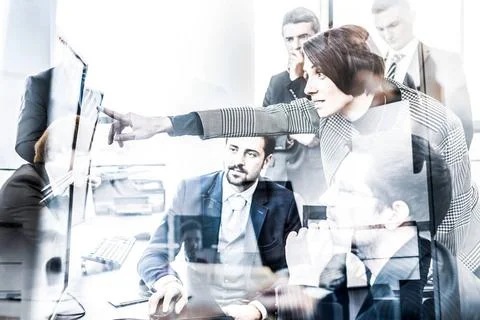 Business team looking at data on multiple computer screens in corporate of... Foto stock