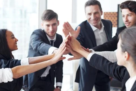 Business team making high five Stock Photos
