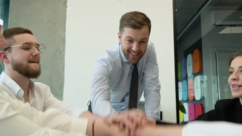 Business team making a stack of hands showing unity. Business people putting Stock Footage 196261038
