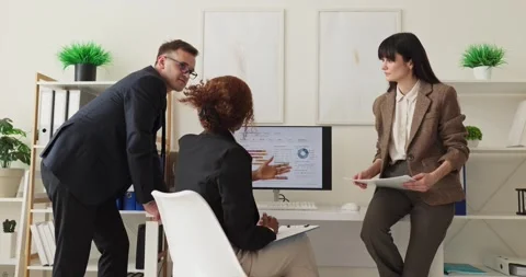 Business team meeting for data analysis strategy around computer in modern Stock Footage 337339022