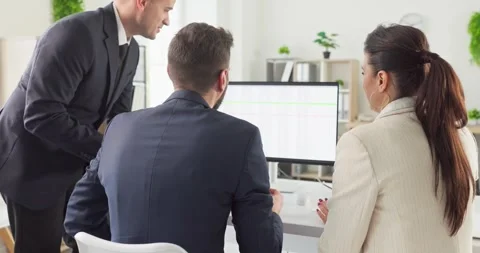Business team in office analyzing data on computer monitor during strategy Stock Footage 325655829