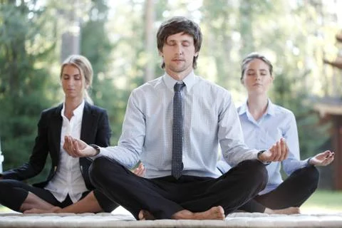 Business team practicing yoga Stock Photos