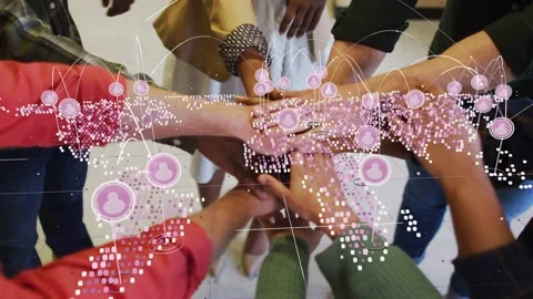 Business team reaching and stacking hands for unity, with pink network overlay 库存影片 337912954